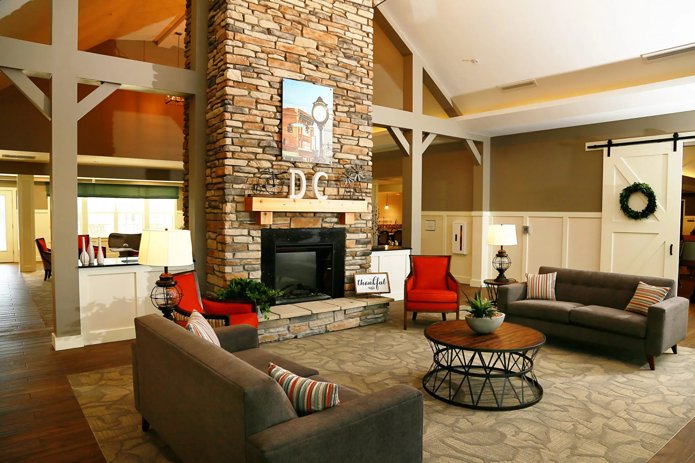 living room with fireplace and couches at senior living facility