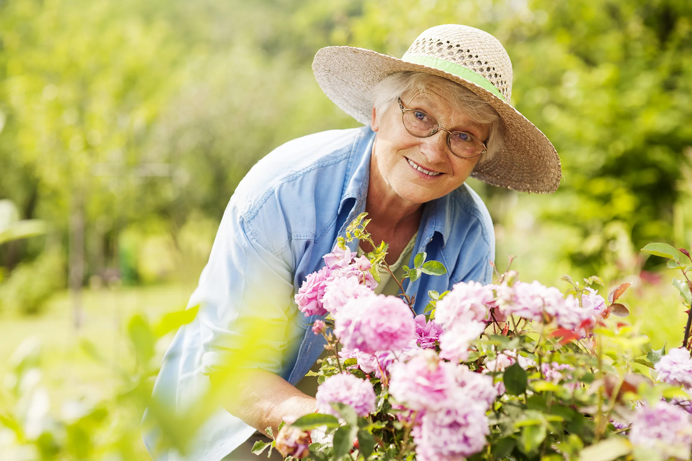 older woman smiling outside gardening