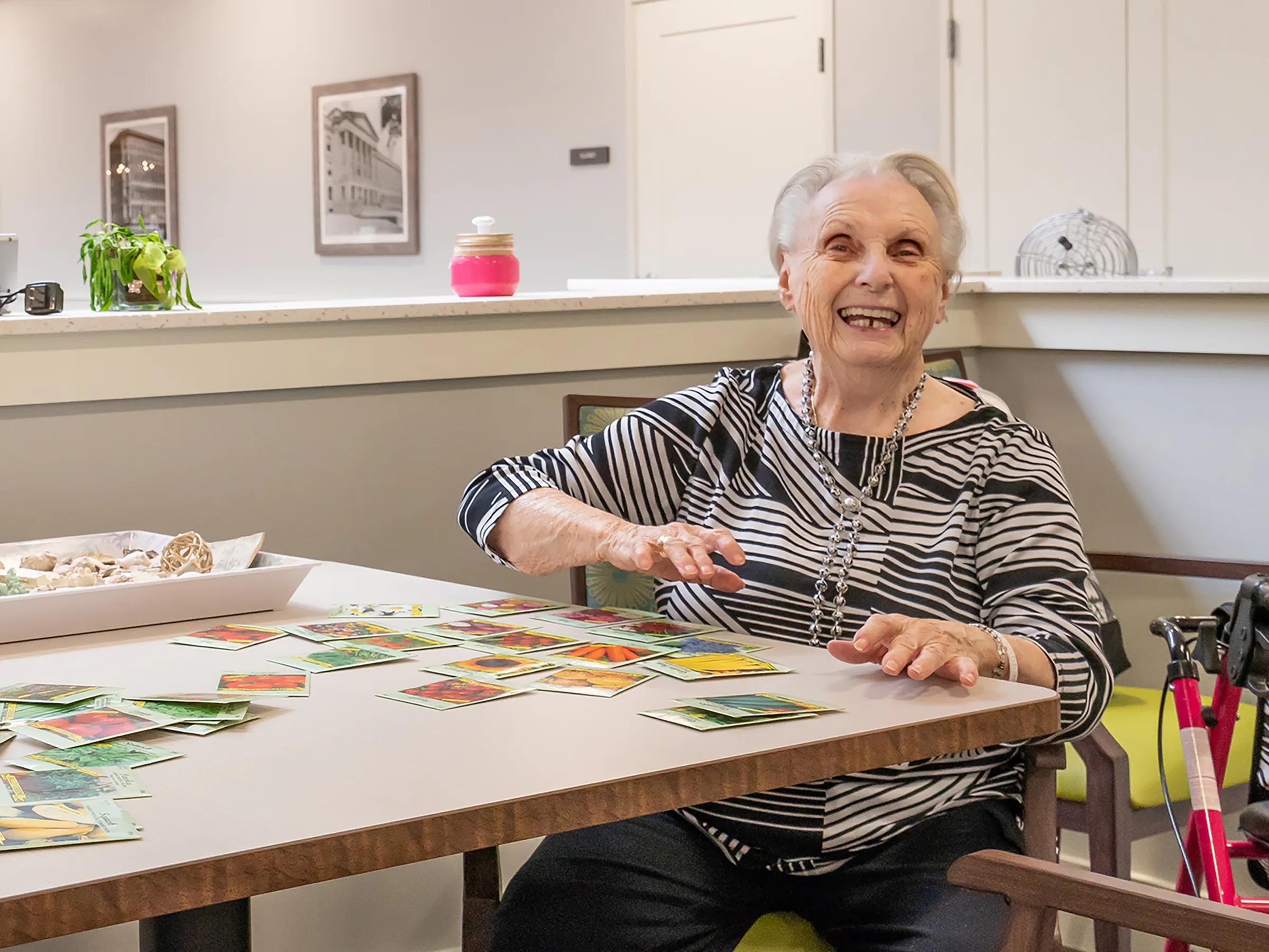 Older woman laughing working with seed packets