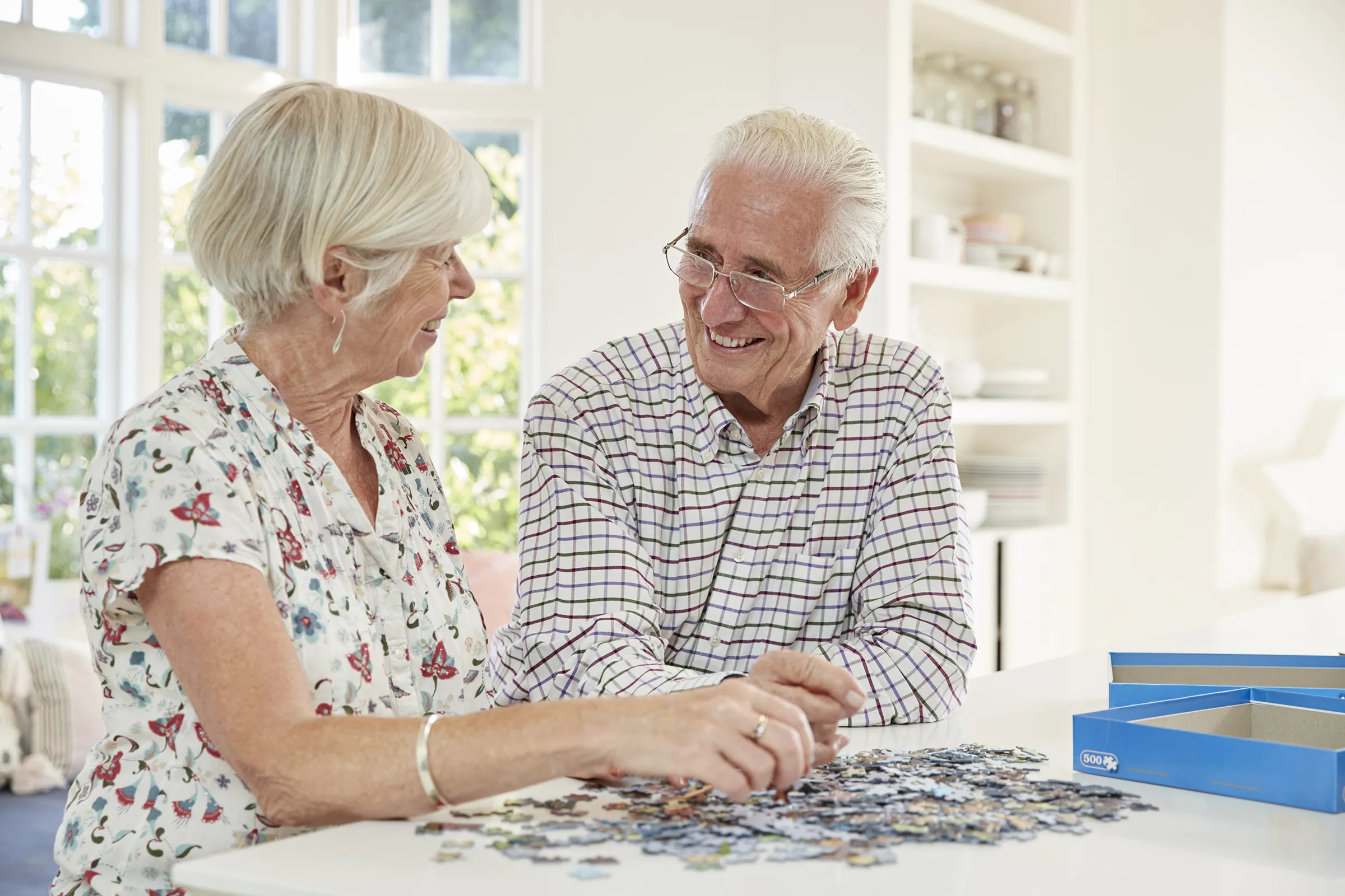 senior couple working on puzzle