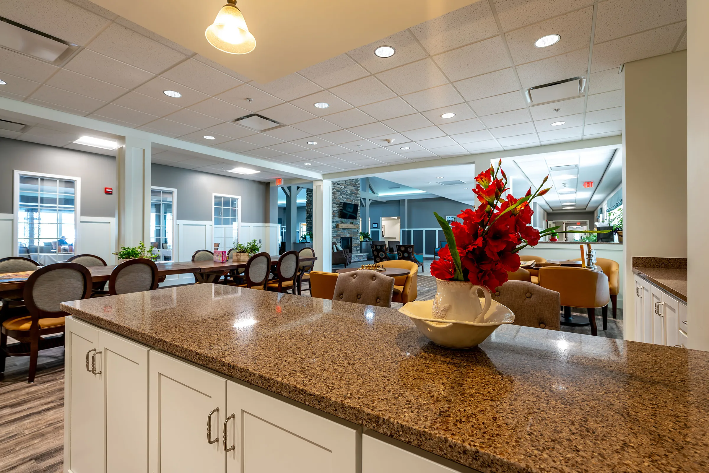view of communal dining area from kitchen in senior living community