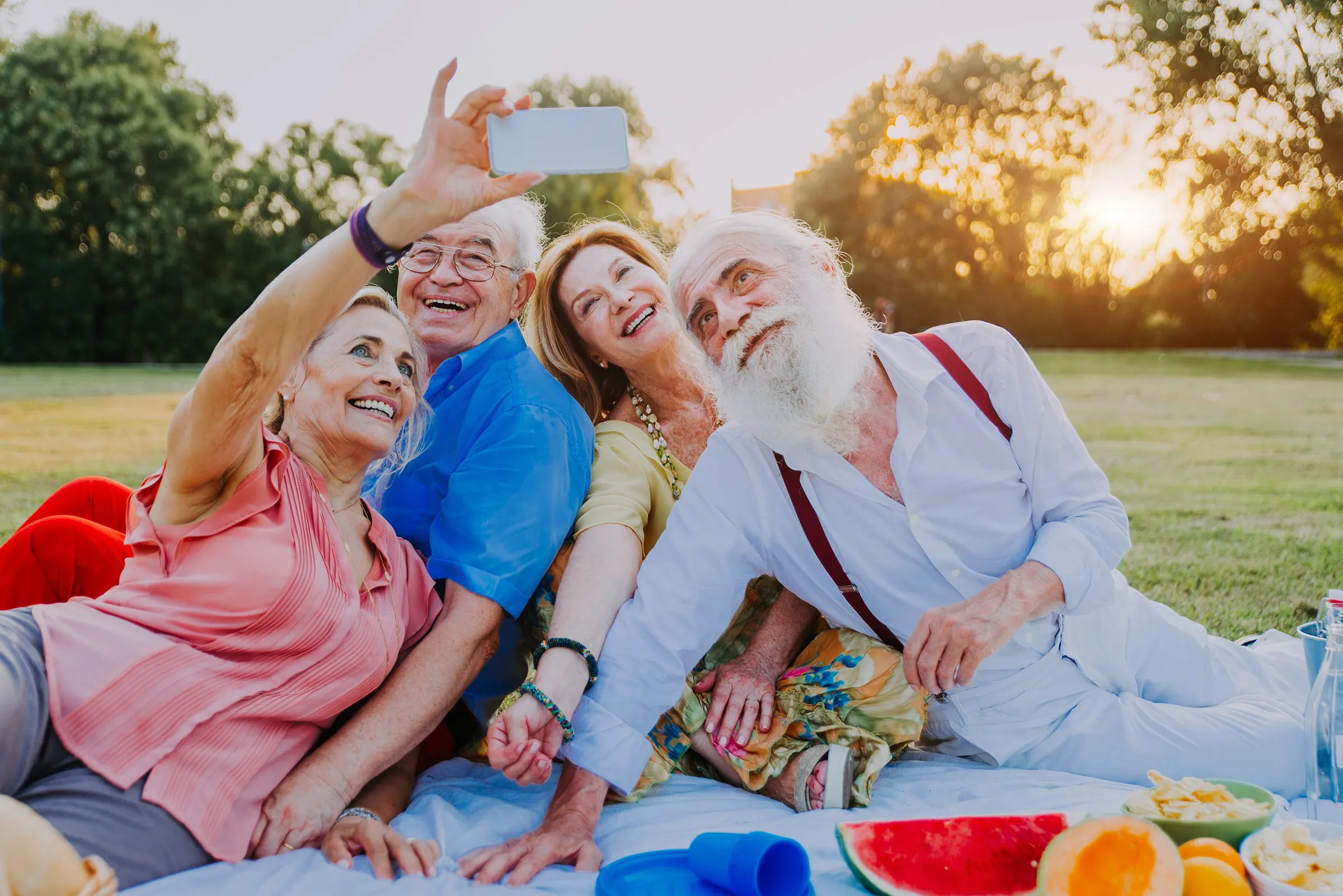 happy seniors taking selfie at picnic