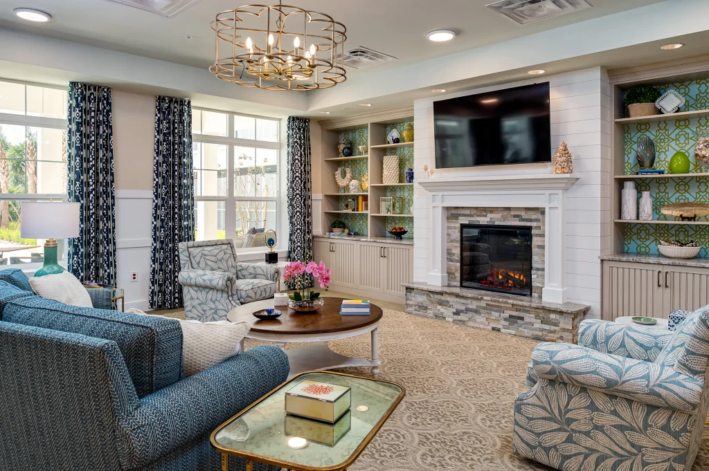 living room with fireplace and couches inside senior living facility