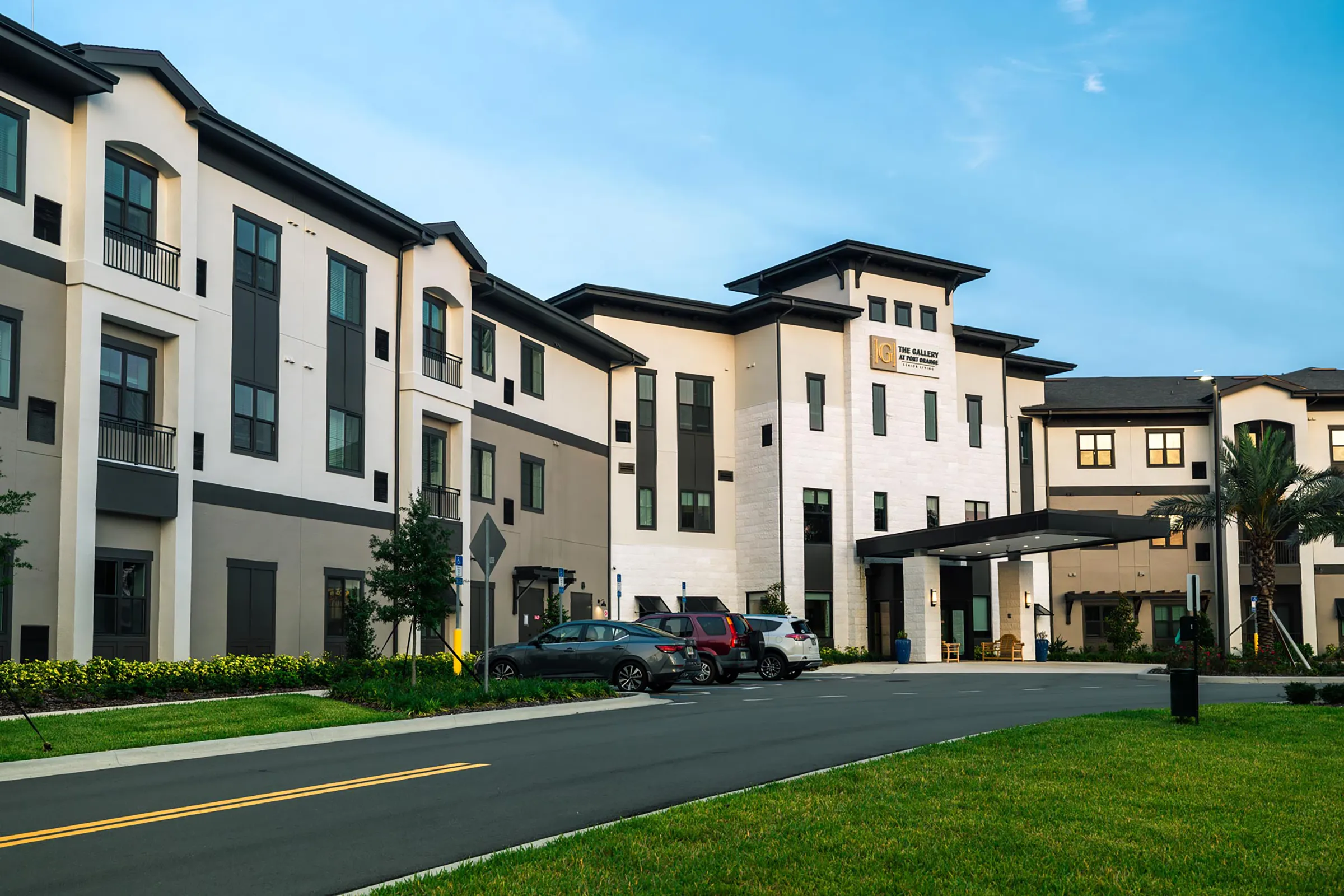 exterior of senior living community with cars parked out front