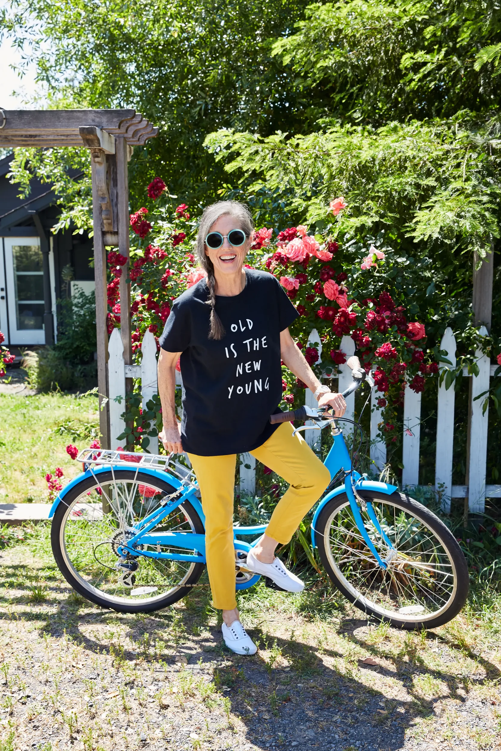 independent living resident standing by bike with old is the new young shirt