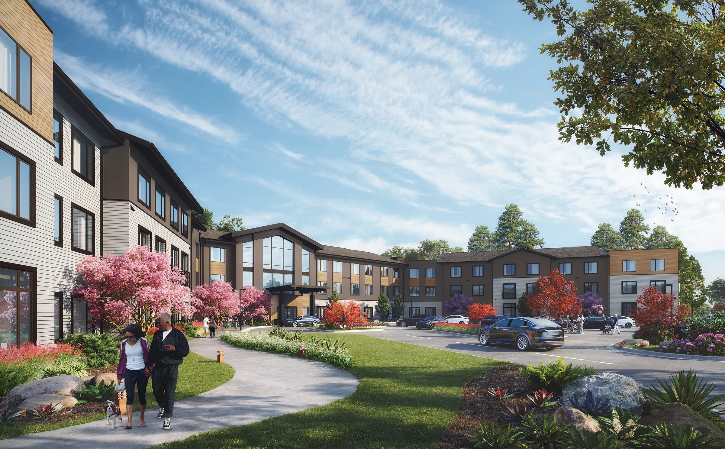 exterior rendering of three story brown and gray senior living community with cars out front