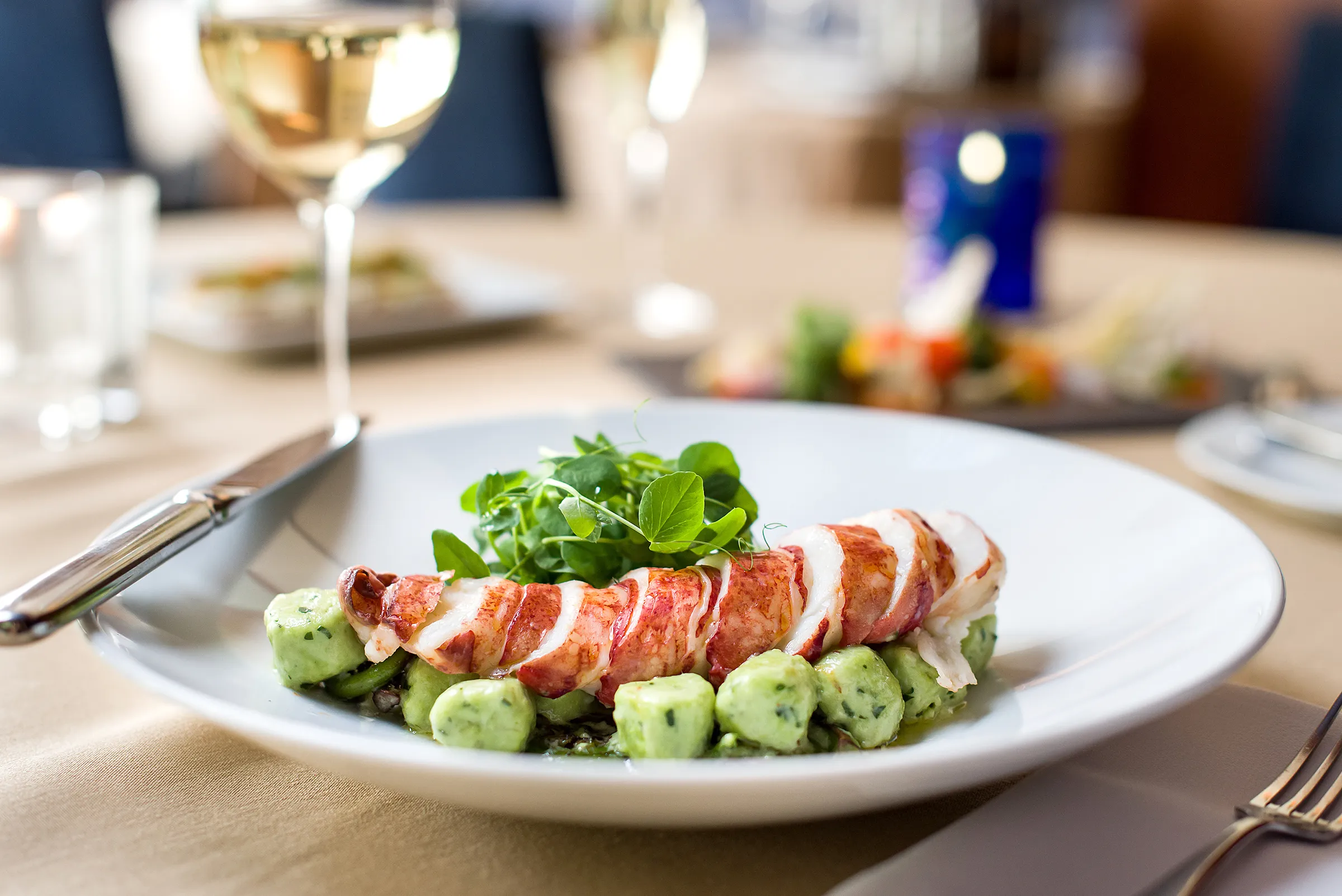 gourmet lobster dish with gnocchi and mache greens